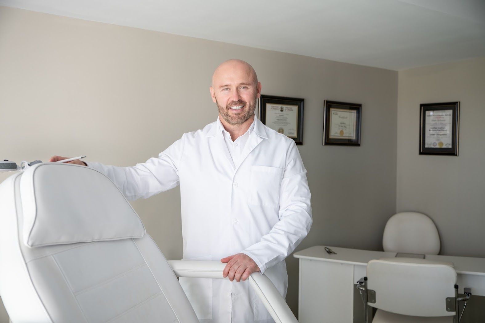 Mark standing beside the treatment chair in the Marvelle clinic